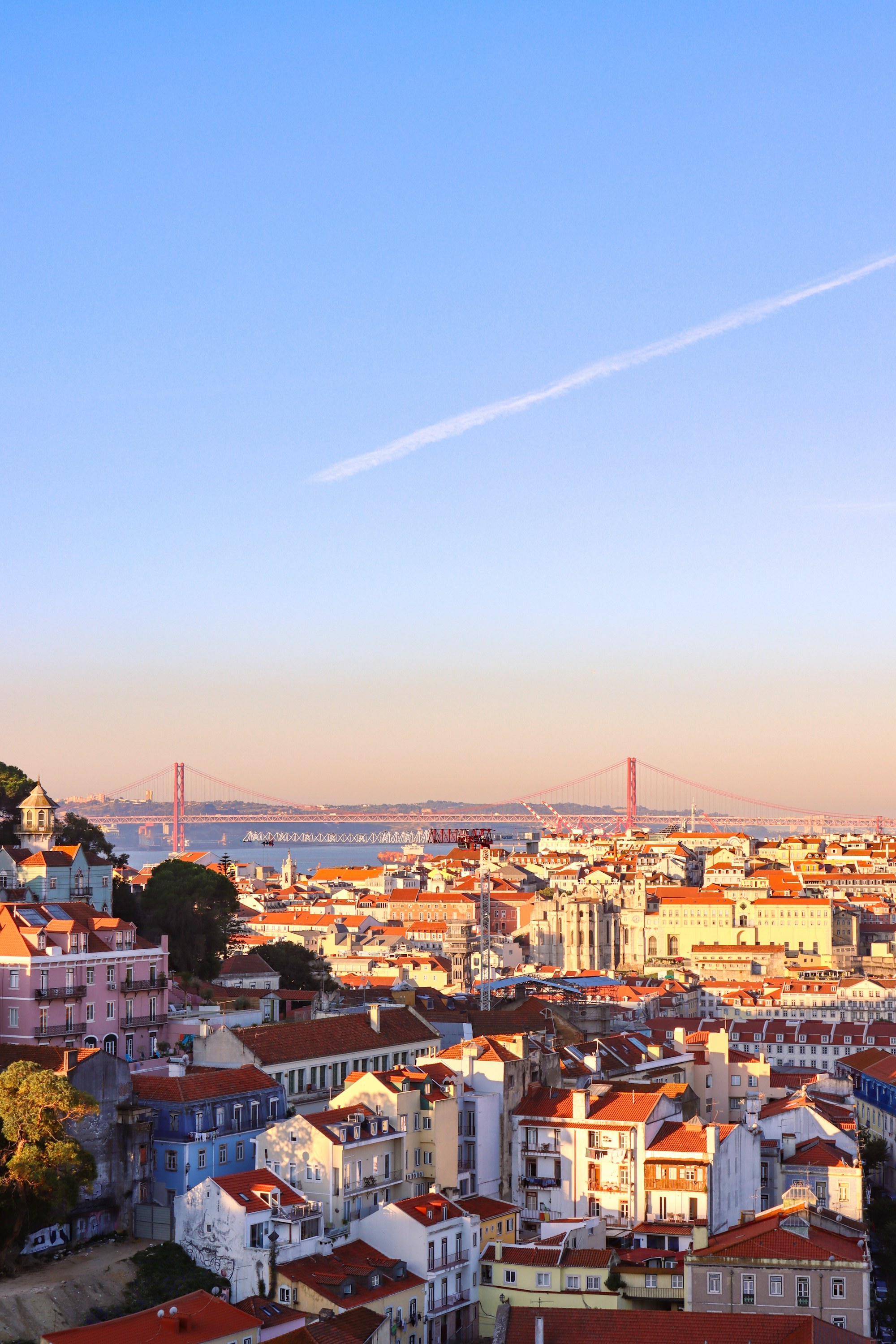 Lisbon rooftops, the Tagus River and 25 de Abril Bridge